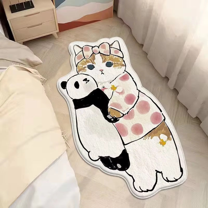 Cute cat shaped rug hugging panda plush placed on bedroom floor beside bed, soft cartoon animal mat for kids room decor