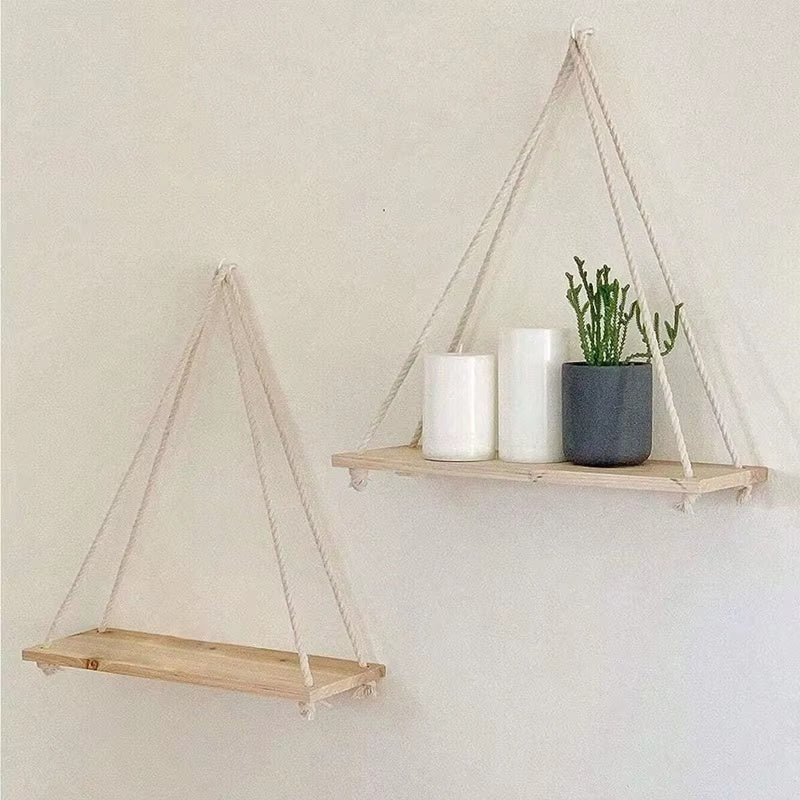 Wooden rope hanging wall shelves set featuring minimalist floating shelves with rope suspension displaying small plants candles and decorative items on a neutral wall
