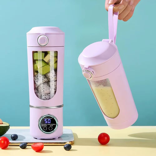 Portable USB rechargeable blender bottle in pink colour with digital display, carrying strap and transparent mixing chamber filled with fresh fruit for smoothies and shakes