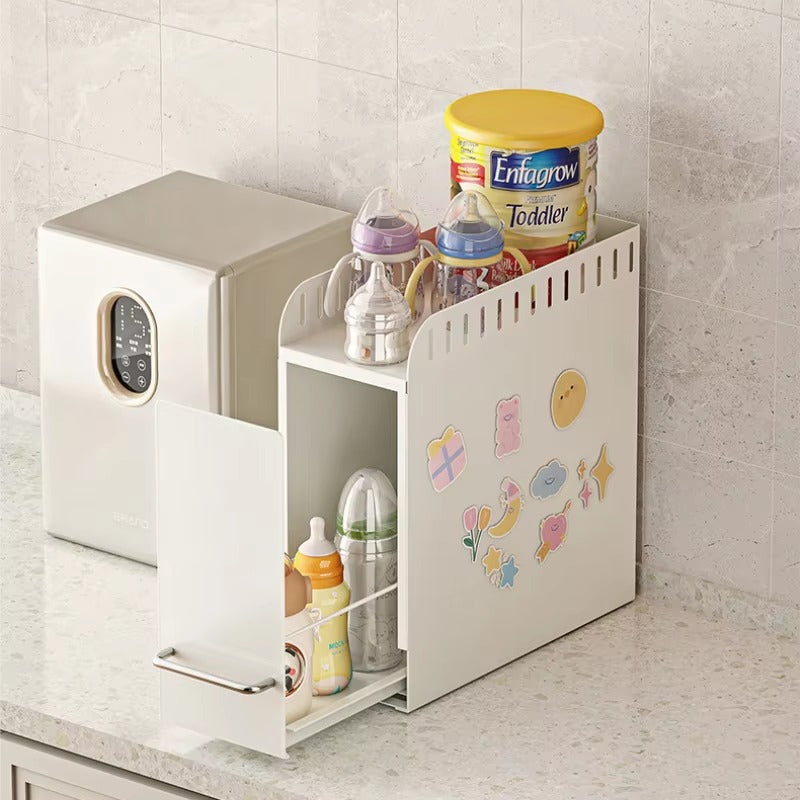 Compact pull-out organizer storing baby bottles, formula, and feeding accessories on a kitchen countertop.