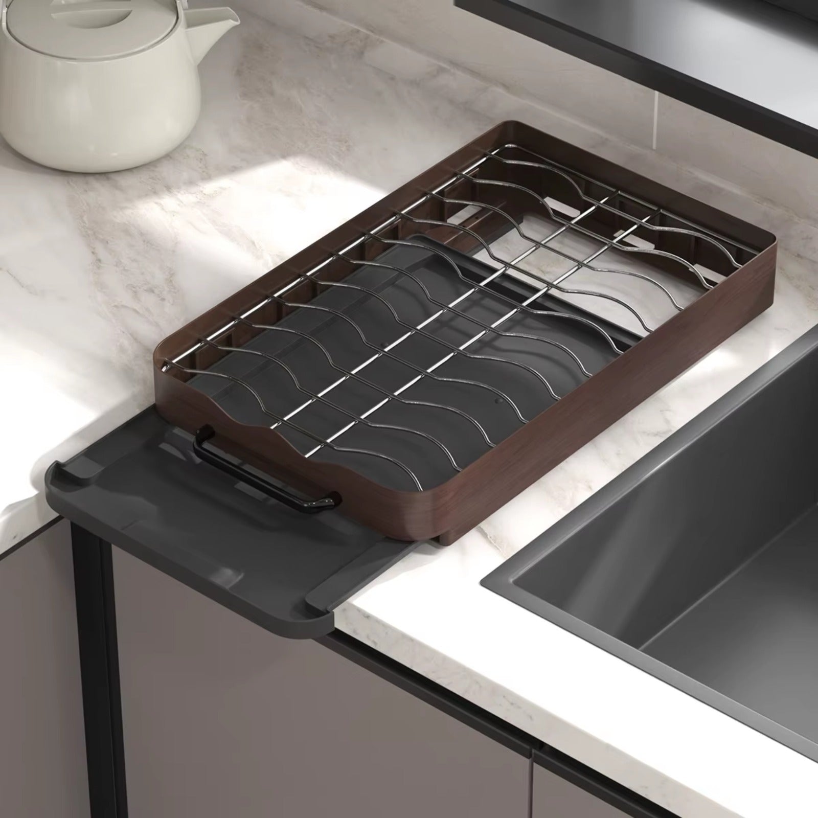 Pull-out cabinet dish rack organizer with metal slots and drip tray, shown empty next to a kitchen sink.