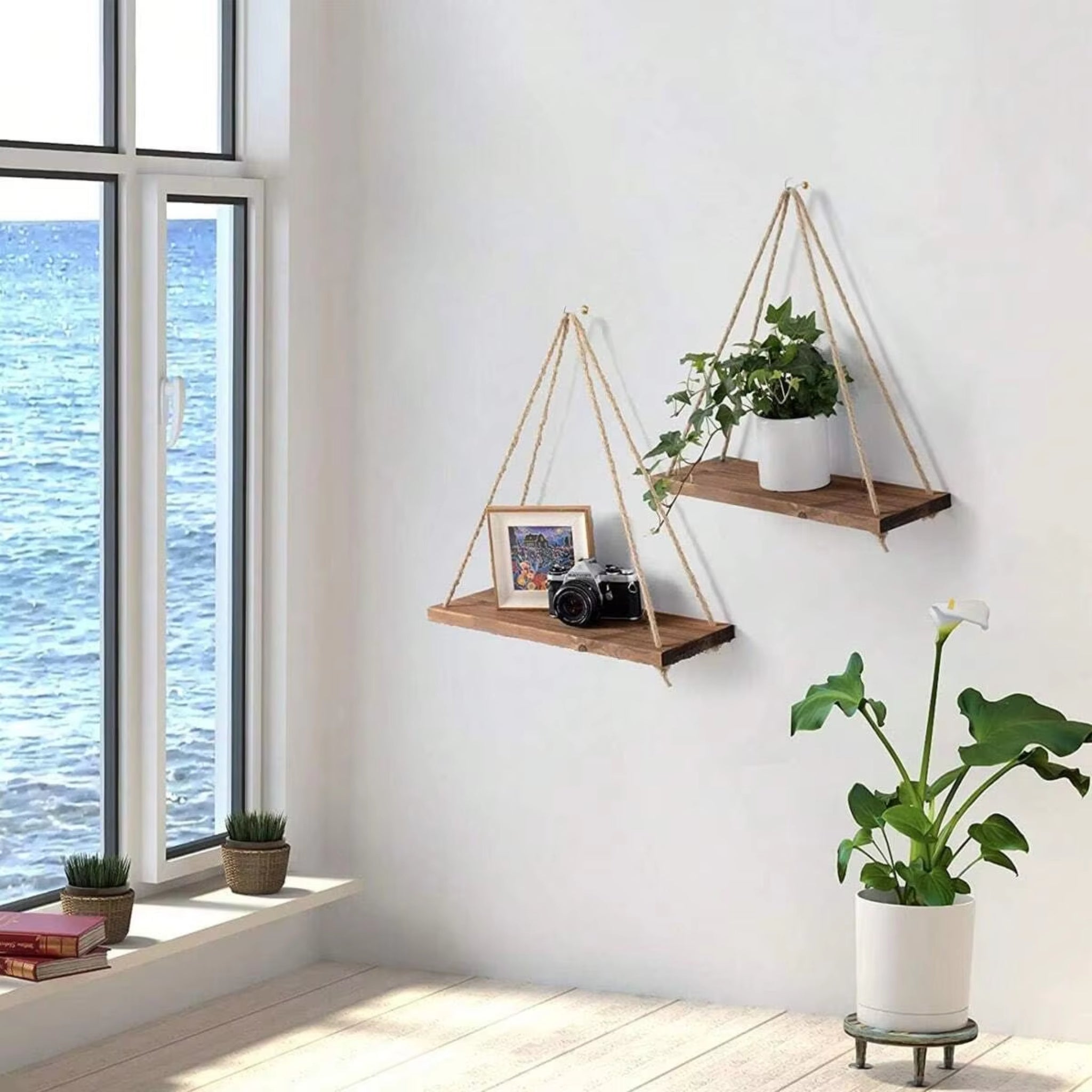 Hanging wooden shelves with plants in a room with large windows.