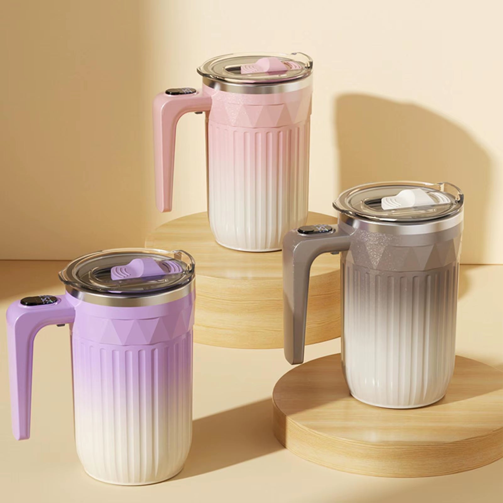 Three smart temperature display travel mugs with insulated double-wall design and spill-resistant lids in pink, grey, and purple color options.