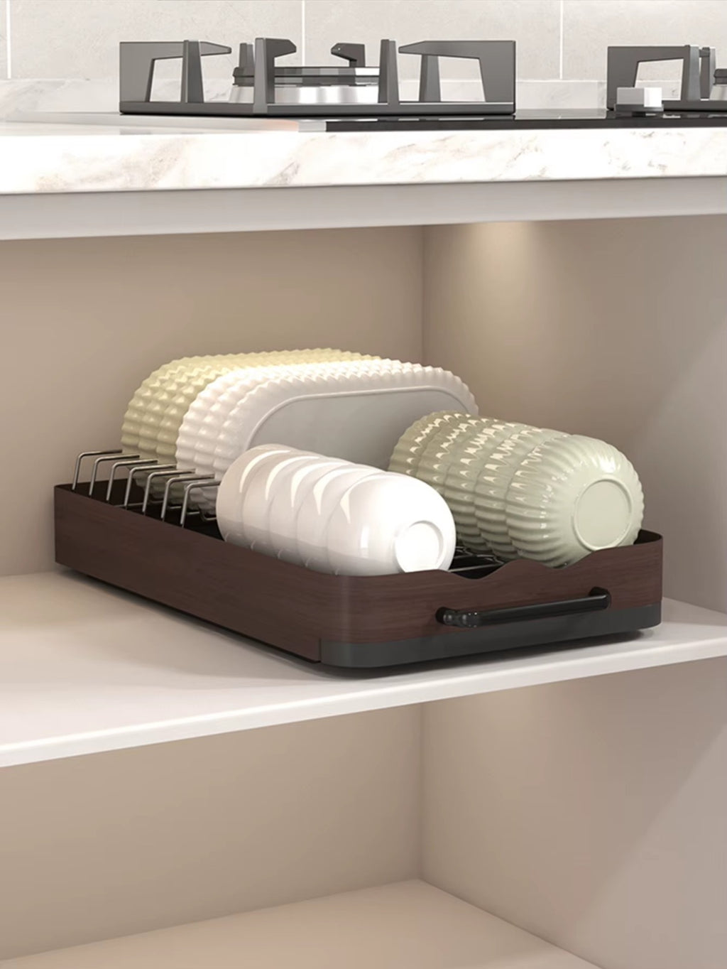 Under-cabinet pull-out dish rack holding plates and bowls neatly organized on a sliding shelf.
