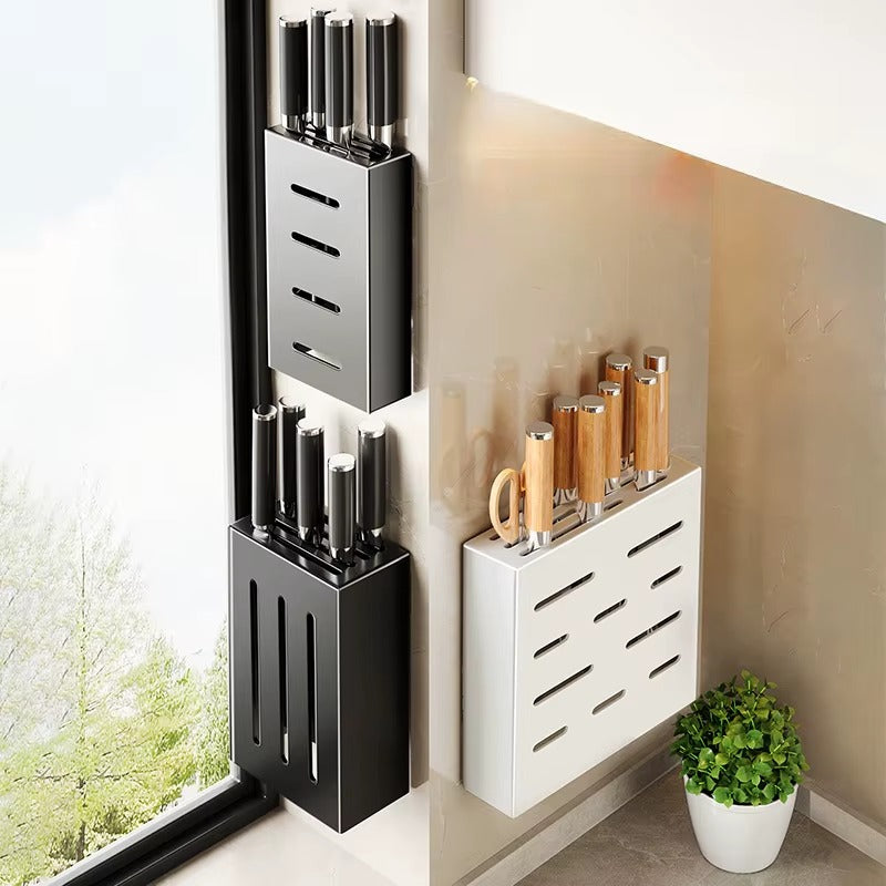 Set of wall-mounted knife holders in black and white finishes displaying knives in a modern kitchen corner.
