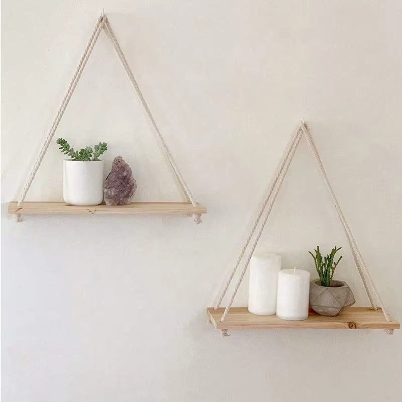 Two triangular hanging shelves with decorative items on a plain wall.