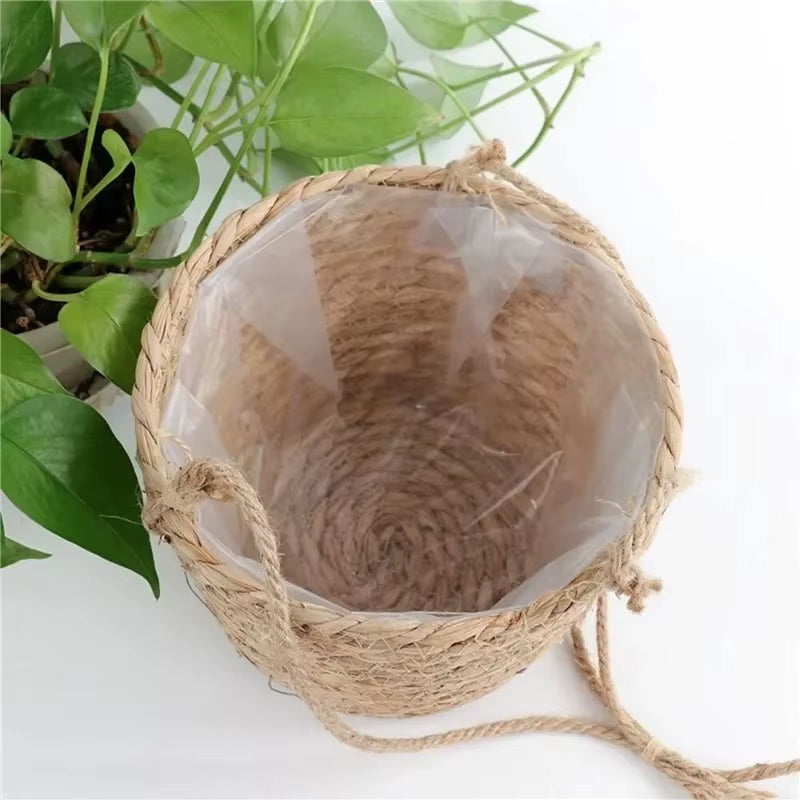 Coconut shell with textured interior on a white surface with green leaves in the background